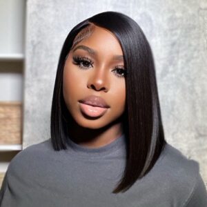 Woman with a 12 inch Asymmetrical Blunt Bob 13x4 Transparent Frontal Lace Wig Straight Human Virgin Hair and glamorous makeup posing for a portrait.