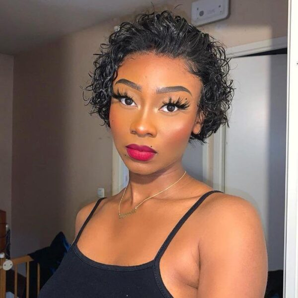 A woman with a Short Curly Pixie Cut 13x4 Lace Front Wig and makeup posing for the camera.